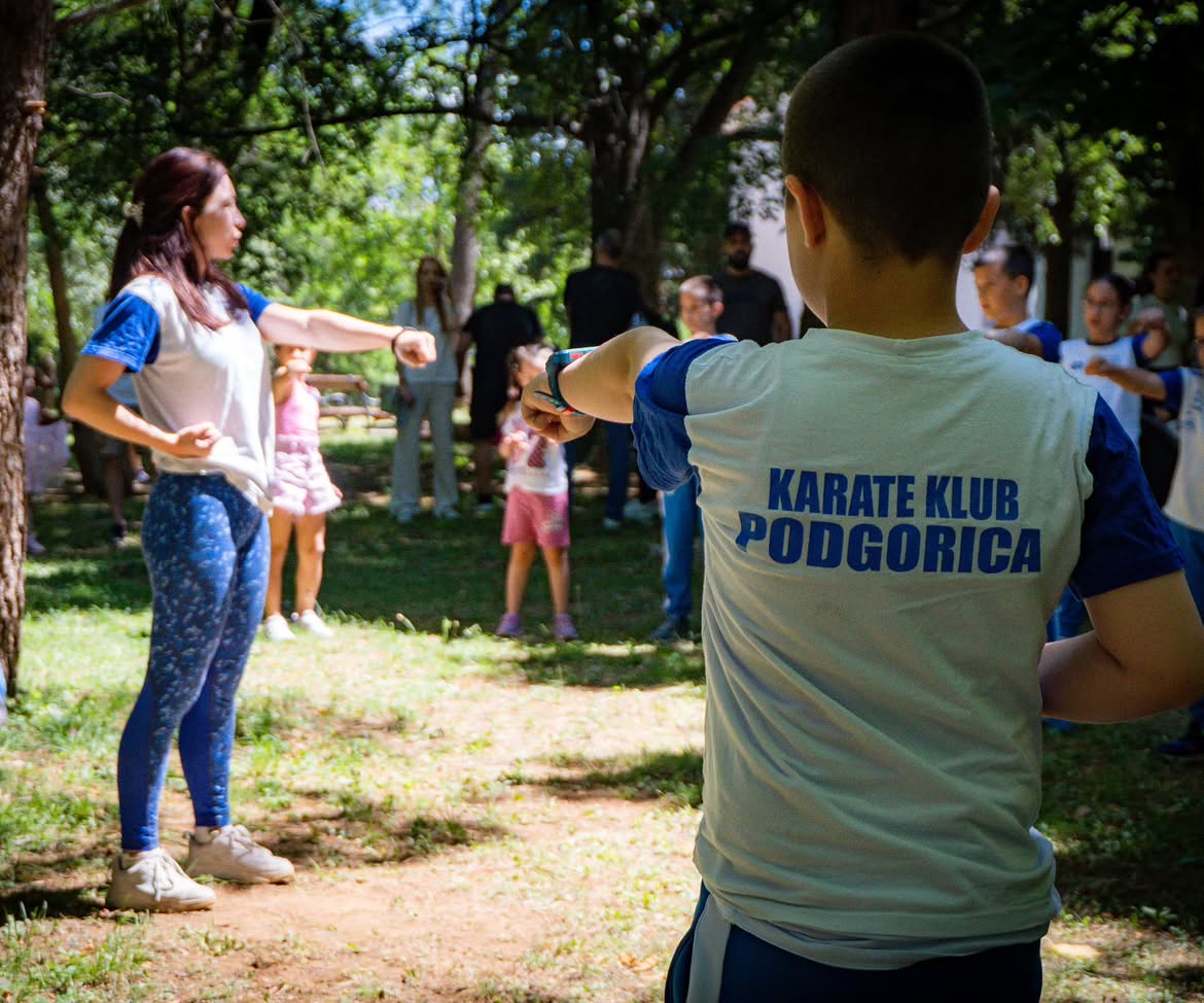 A child in a club T-shirt taking part in an outdoor activity