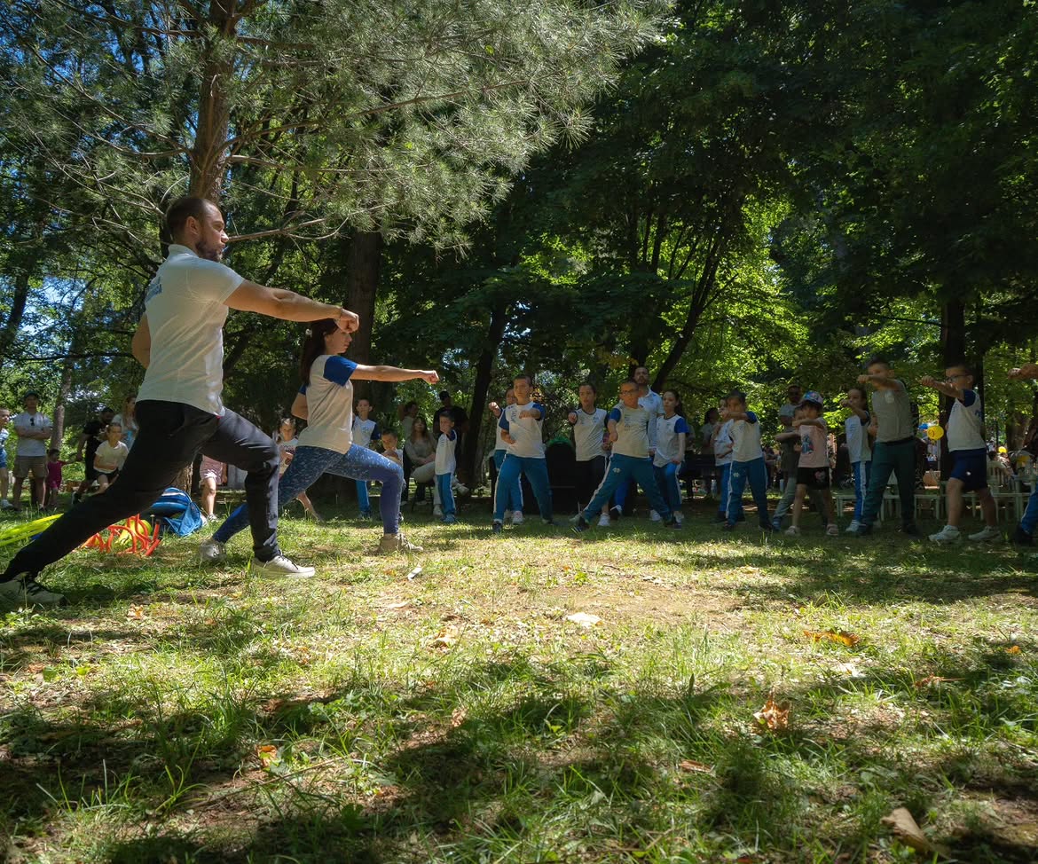 Children and adults exercising together in a park